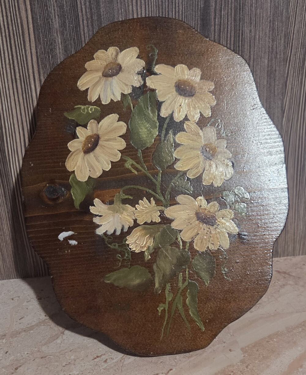 vintage hand-painted wooden bread board or wall hanging with a floral design.